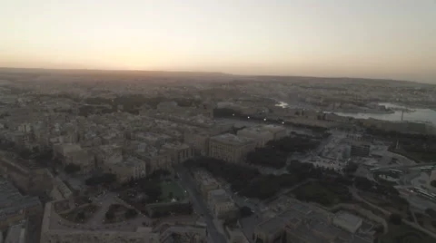 Aerial Shot moving backwards over a city during Sunset Stock Footage 61258382