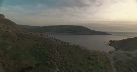 Aerial Shot moving backwards over a hill during Sunset Stock Footage 67152598
