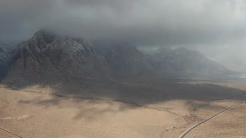Aerial shot of moving dark clouds, snow flurries, hail, fog in Red Rock Canyon Stock Footage 120587706