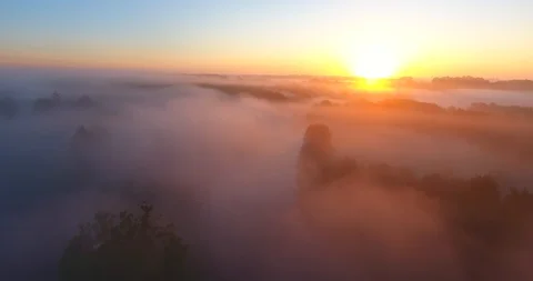 Aerial shot, moving down over green hills into morning fog 8 Stock Footage 108835203
