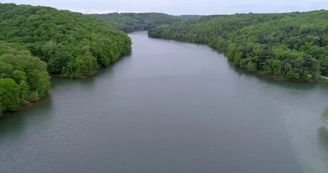 Aerial Shot Moving Down A River With Wooded Banks Vídeo Stock 92703705