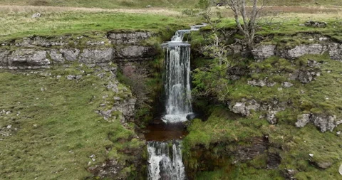 Aerial shot of multi layer waterfall on a hillside Stock Footage 220105655