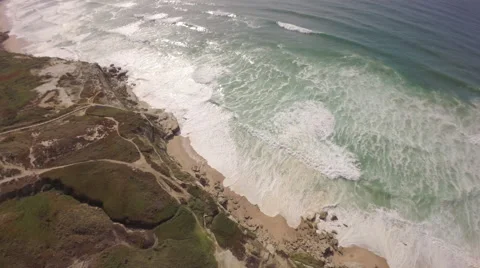 Aerial shot of ocean front cliffs in Praia de Santa Cruz - Portugal Stock Footage 64631799