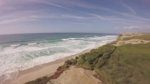 Aerial shot of ocean front cliffs in Praia de Santa Cruz - Portugal Stock Footage 64632707