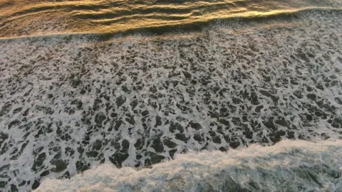 Aerial shot of ocean waves during sunset Stock Footage 202153214