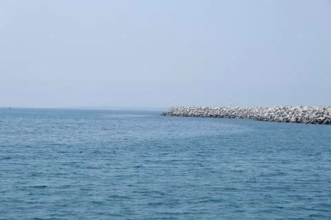 Aerial shot of the open sea on a cloudy day. Blue sky, ships in the distance and Stock Photos