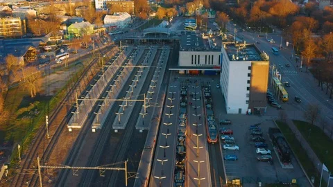 Aerial shot opening onto a small train station and the city (trademarks blurred) Stock Footage 98908000