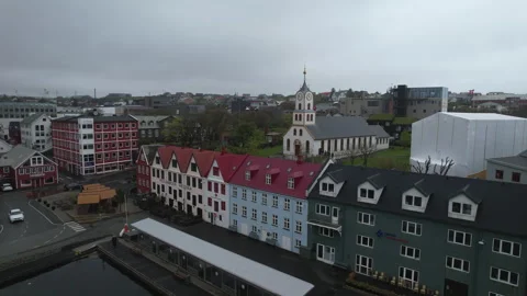 Aerial shot in orbit and from the side of the buildings in the port of TORSHAVN Stock Footage 245946217