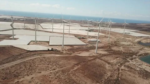 Aerial shot in orbit over a wind farm in an almost desert environment Stock Footage 246053465