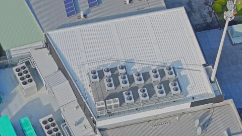 Aerial shot orbiting hvac units on an industrial rooftop Stock Footage 340594409
