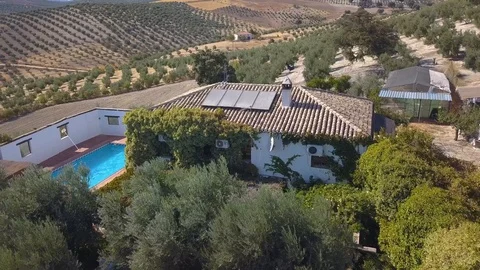 Aerial shot over a big house in the spanish countryside with solar panels Vídeos de archivo 115636498
