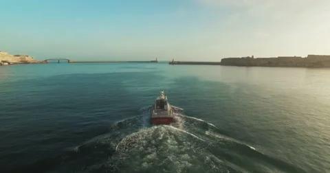 Aerial Shot over a boat between islands Stock Footage 61337302