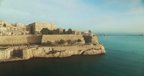 Aerial Shot over City between blue skies and blue sea Stock Footage 61340940