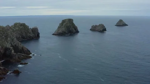 Aerial shot over the cliffs and rocky islands in the ocean, in Brittany, France Stock Footage 195161307