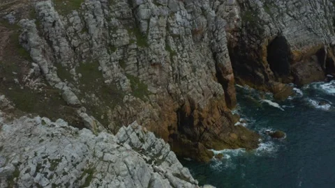 Aerial shot over the cliffs that go into the ocean, in Brittany, France Stock Footage 195157817