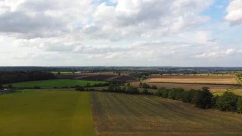 Aerial shot over farm fields in the UK Stock Footage 250627447