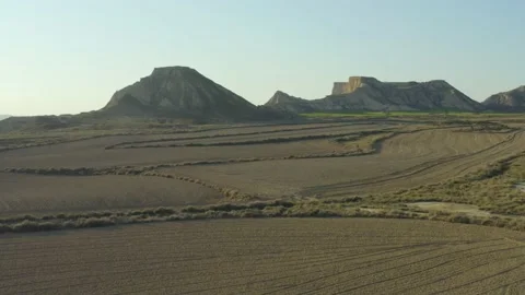 Aerial shot over fields in a desert with mountains, in Bardenas Reales, Spain Stock Footage 194744938