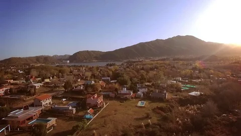 Aerial shot over houses with mountains and lake view Stock Footage