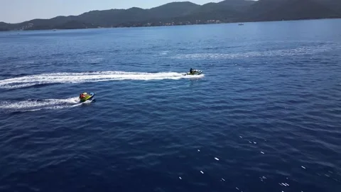 Aerial Shot Over Jetski Pulling a Tube on sea Stock Footage 216919321