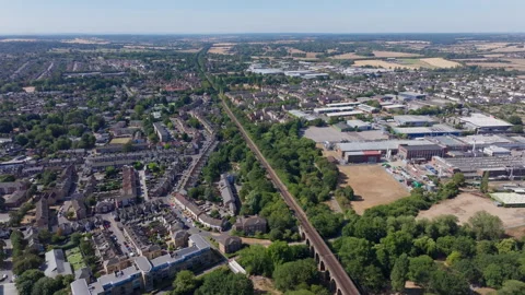 Aerial shot over a long set of train tracks passing through suburban Chelmsford Video stock 345778687