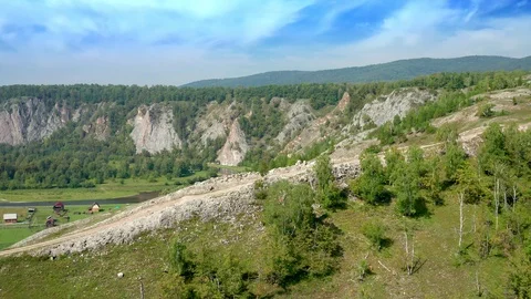 Aerial shot over a mountain range and a river valley. Stock Footage 114726637