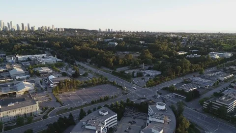 Aerial Shot Over Offices By Intersection With City In Background Stock Footage 100530904