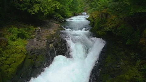 Aerial shot over river and small waterfall Stock Footage 314548786