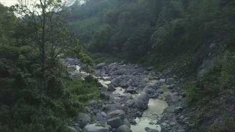 Aerial shot over a river surrounded by forest, in Darjeeling, India Stock Footage 238803715