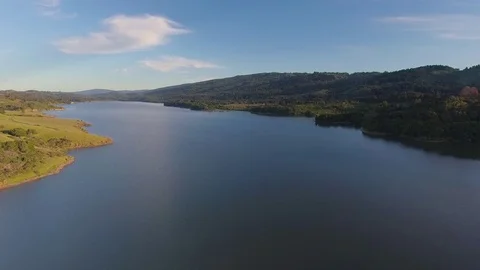 Aerial shot over San Mateo Crystal Springs Reservoir lake hills summer day Stock Footage