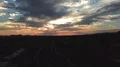 aerial shot over split lane road towards colorful sunset HD Footage