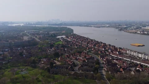Aerial shot over the Thames River with London skyline in the distance 스톡 동영상 332622947