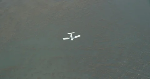 Aerial shot over turboprop flying above coastline, day Stock Footage 105502653