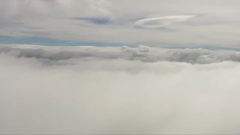 Aerial shot overhead a large white cloud formation from a helicopter Stock Footage 235426880