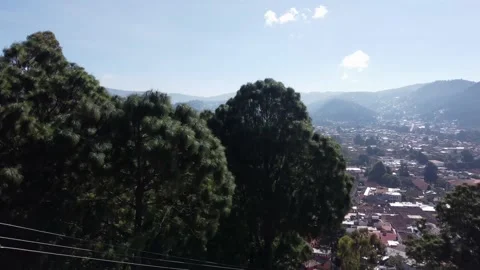 Aerial shot passing over the trees view on the Mexican city located in the Stock Footage 166187034