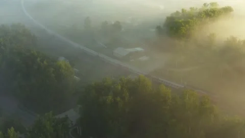 Aerial shot. A Passing Train in the Fog in the Morning. Stock Footage
