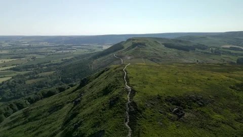 Aerial shot of path over a ridge and into the distance Stock Footage 253554432