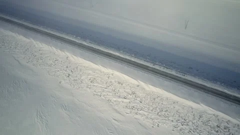 Aerial Shot pitching down over snowy highway Stock Footage 268645115