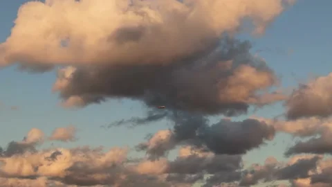 Aerial Shot of Plane Passing by between Sunset Clouds Stock Footage 158963540
