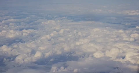 Aerial shot from a plane window of beautiful white clouds, 2026 Stock Footage 339057589