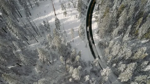 Aerial shot pointed down and following a truck in winter landscape. 库存影片 102979494