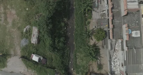 Aerial shot of a polluted stream in a poor community Stock Footage 139969307