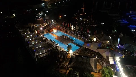 Aerial Shot of a Pool Party with Dancers at Night Time Stock Footage