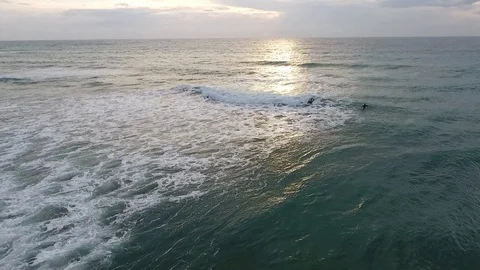 Aerial shot of a professional surfer chatching waves in Italy during sunset Stock Footage 89785299