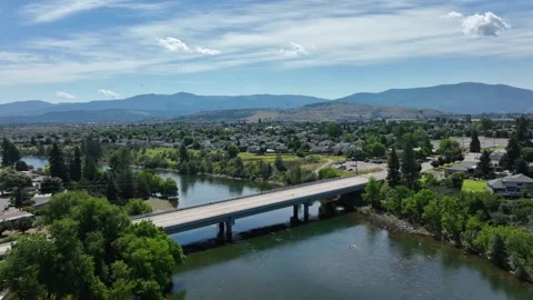Aerial shot pulling away from a bridge crossing the Spokane River. Stock Footage 202109404