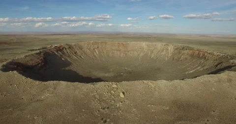 Aerial shot pulling away from Meteor Crater Stock Footage