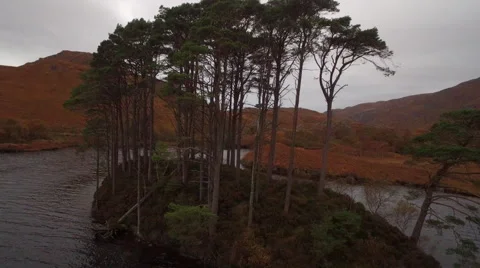 Aerial shot pulling away from small island in highland loch setting Video stock 64660144