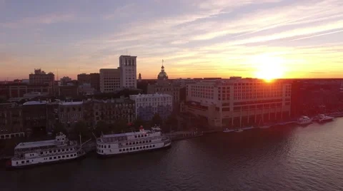 Aerial Shot Pulling Back From the Waterfront in Savannah with Sun Popping Throug Stock Footage 57714352