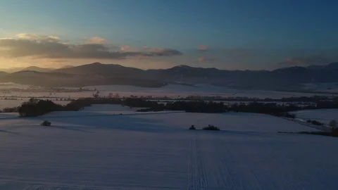 Aerial shot pulling to the Drone pilot standing by the car and record the Video stock 102336324
