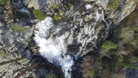 Aerial shot, quickly descending down a waterfall tilting up and over trees Stock Footage 90643049
