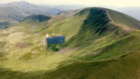 Aerial shot of a rectangular pond in the Carpathian uplands in summer Stock Footage 93844415
